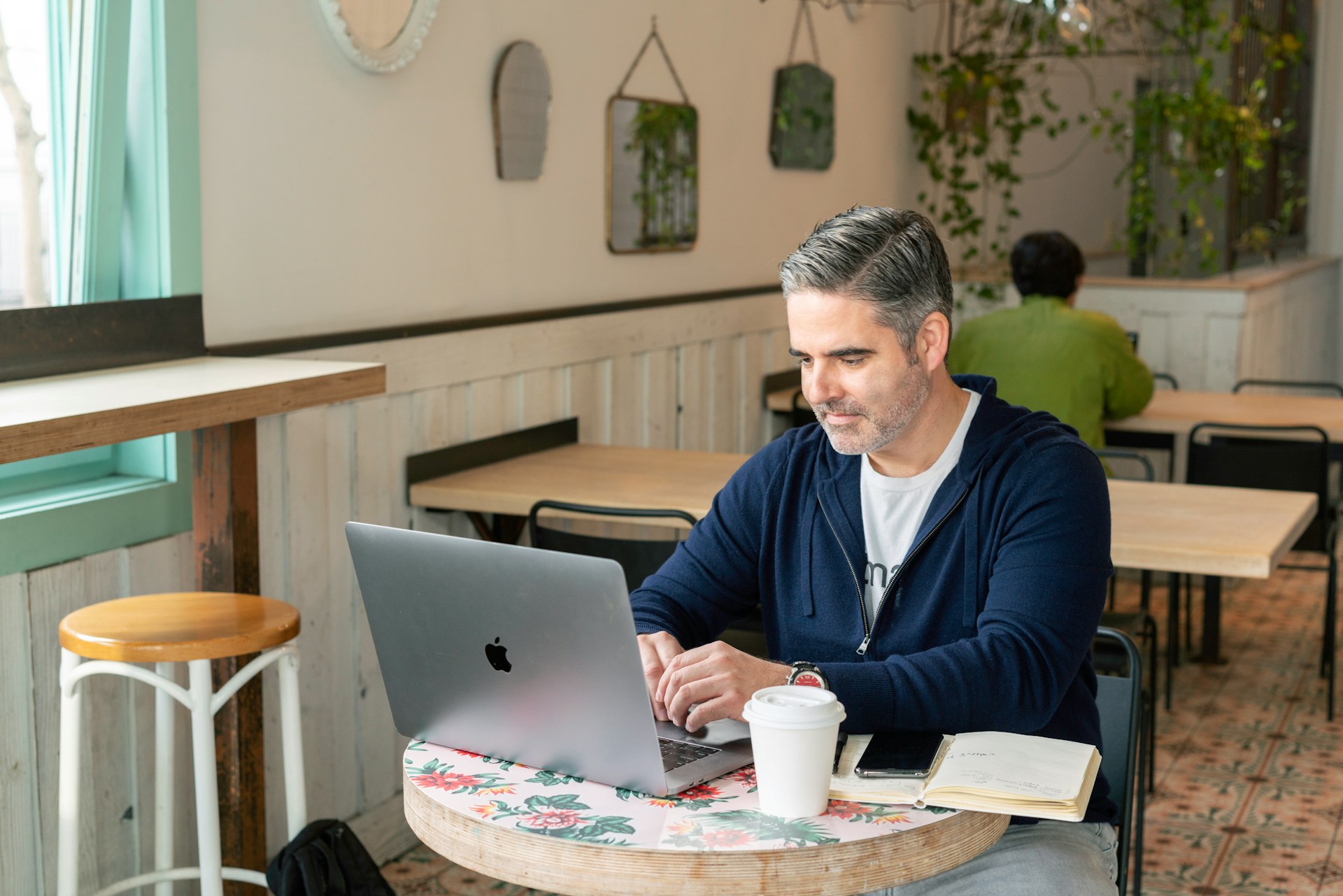 Man in blue sweater with macbook