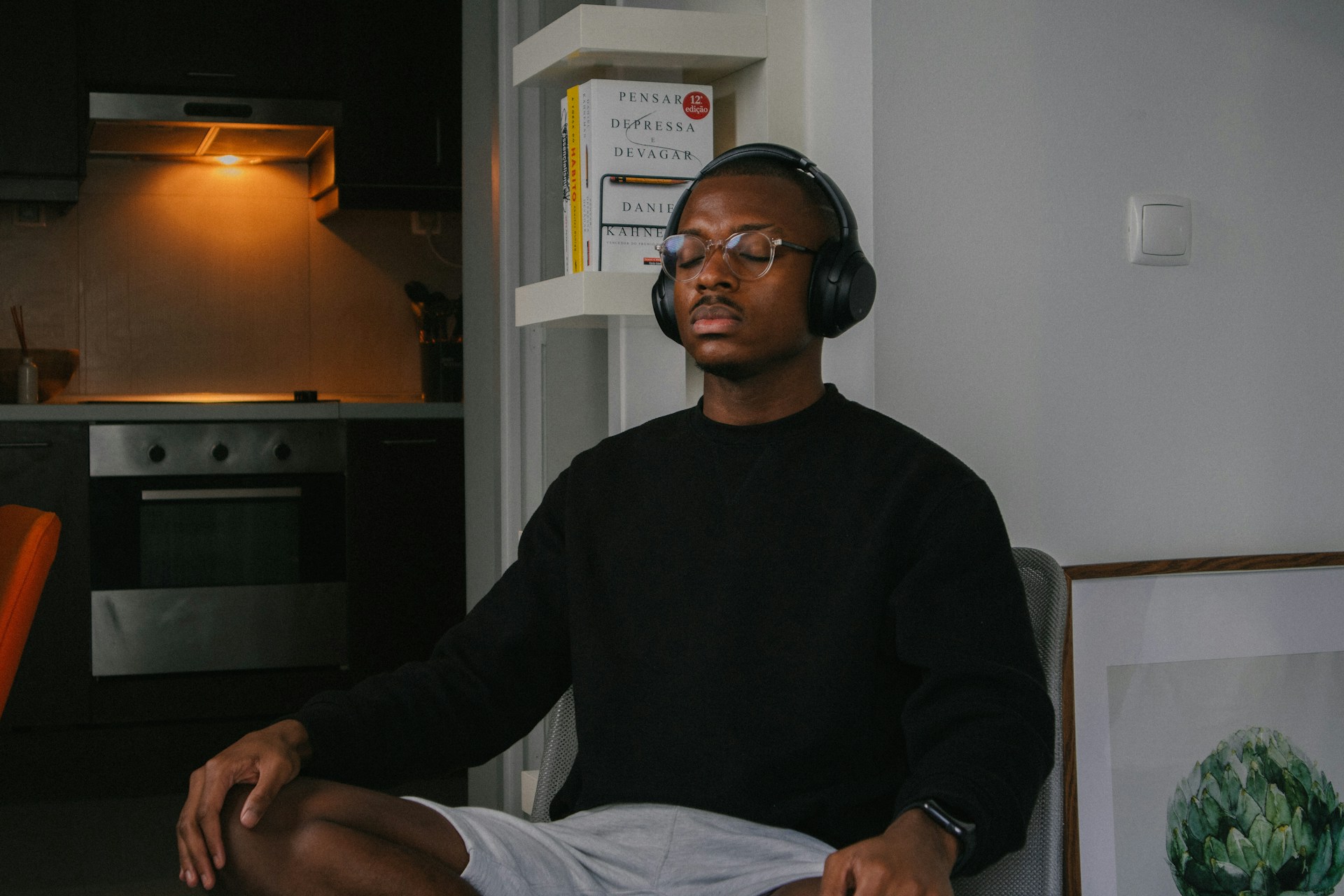 Man in chair with headphones meditating in mindfullness 