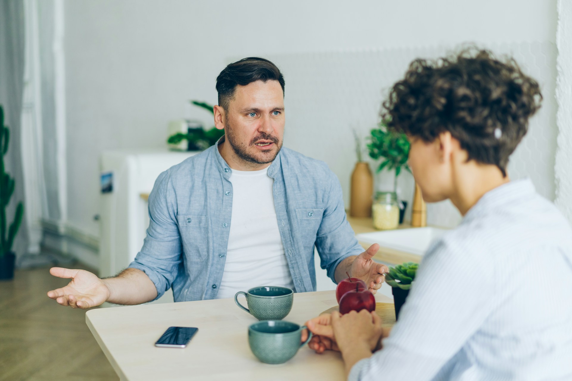 Man at Table Talking to Woman